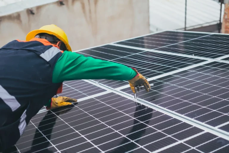 Man performing maintenance on a solar panel